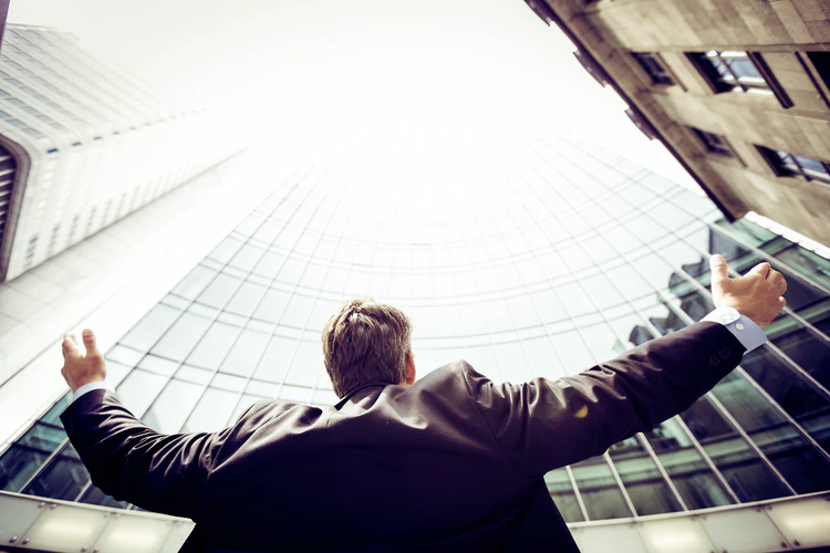 man opening arms to sky